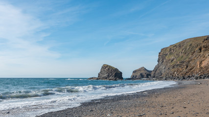 A rural rocky beach located in amongst of the cliffs of Cornwall, England.