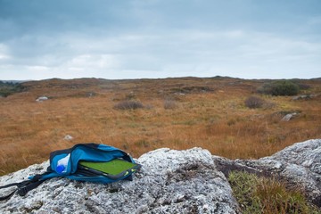 Digital tablet in backpack lying on rock, Connemara, Ireland