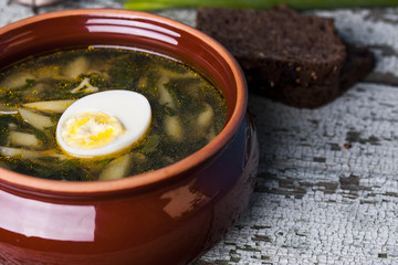 Nettle soup with eggs in the bowl