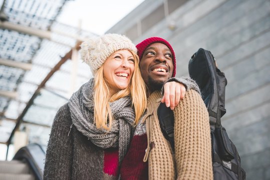 Couple smiling, leaving mall