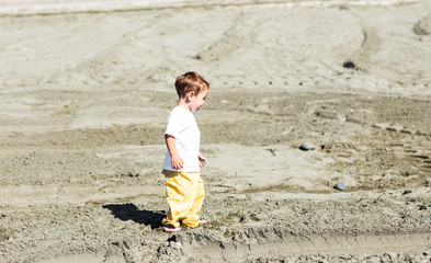 Little boy walking on a beautiful tropical beach
