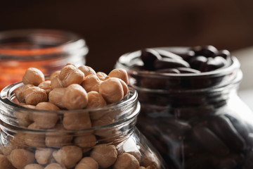 Chickpeas and red beans in glass jars macro shot