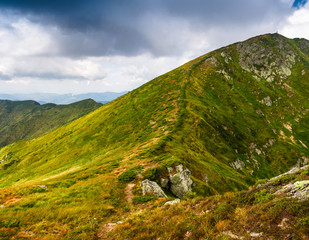 Fototapeta premium View of panoramic mountains landscape of a rocky cliffs and green hills.