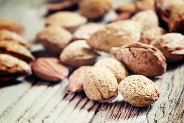 Salted almonds in shell on a vintage wooden background, selectiv