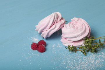 Fresh pink homemade zephyr - marshmallow on blue wooden table