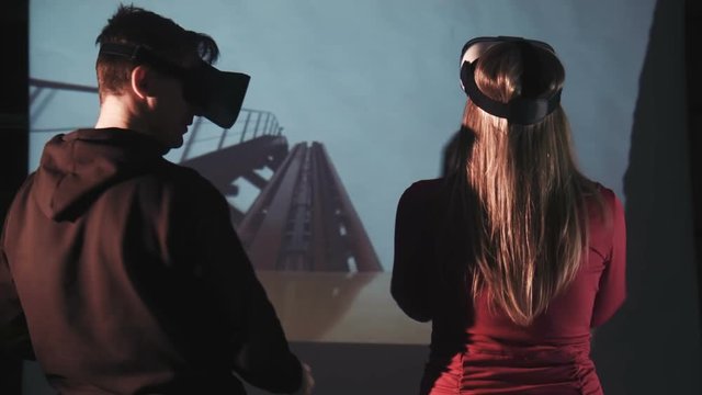 Smiling Couple In Oculus Rift Having Fun On Rollercoaster