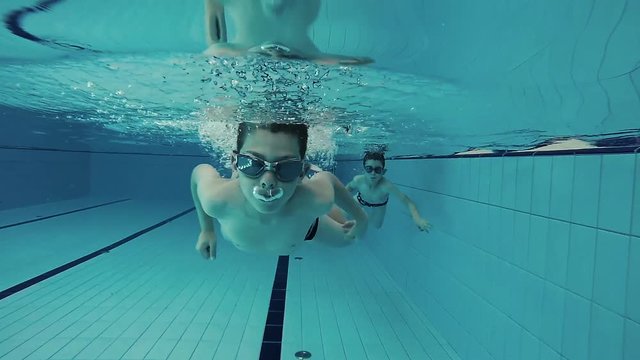 Underwater shot of boys swimming in the pool