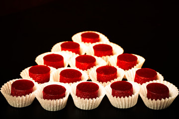 Berry jelly candy on the black table. Toned