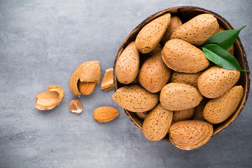 Group of almond nuts with leaves.Wooden background.