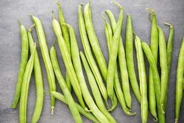 Green beans  on a gray background.