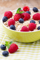 Oatmeal porridge with berries. Raspberries and blueberries.