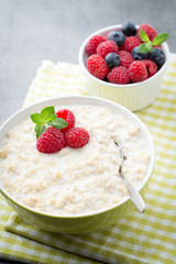 Oatmeal porridge in bowl with berries raspberries and blackberri