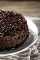 Tasty chocolate cake on wooden background