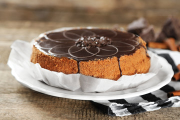 Tasty chocolate cake on wooden background