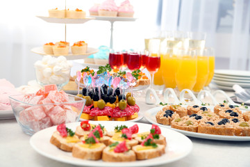 Set of cold snacks, canape, beverages and dessert, closeup