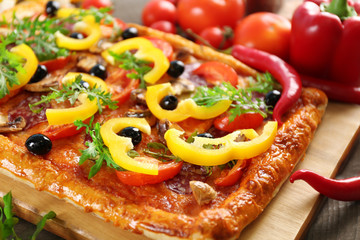 Rectangle delicious pizza and vegetables on the table, close-up