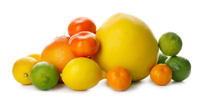 A heap of mixed citrus fruit including   lemons, limes, grapefruit, pomelo and tangerines isolated on a white background, close up