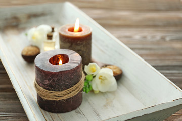 Spa set with sea salt, flowers and candles on wooden background