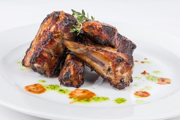 hot smoked barbecue ribs on white plate