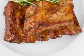 hot smoked barbecue ribs on white plate