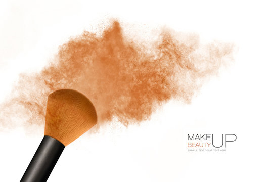 Makeup concept. Cosmetic brush with bronzing powder explosion