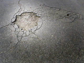 Cracked damaged asphalt street with a big hole - 109171934