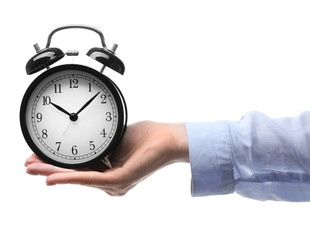 A retro alarm-clock on female hand, isolated on white