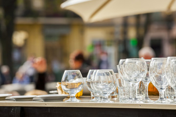 Open-air restaurant. Wine glasses.