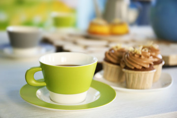 Obraz na płótnie Canvas Table setting with tea and cakes indoors
