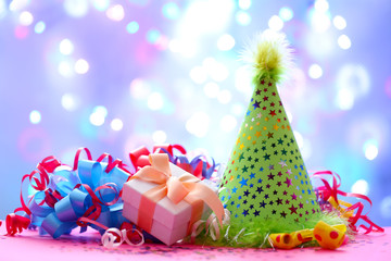 Party hat and other stuff on blurred garland background