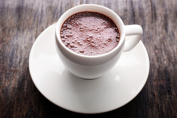 Cup of hot coffee on rustic wooden background