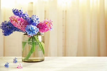 Hyacinth flowers on table in front of curtain background