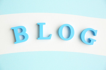 Word BLOG from blue letters on striped background