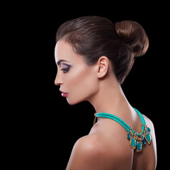 portrait brunette woman with jewelry and luxury make up