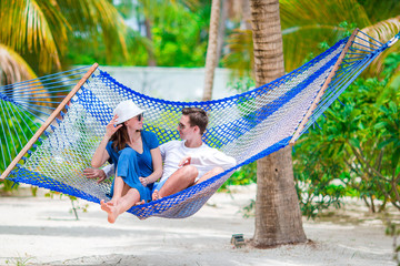 Family on summer vacation relaxing in hammock