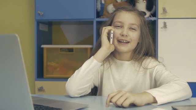 Cute Little Girl using Modern Smartphone
