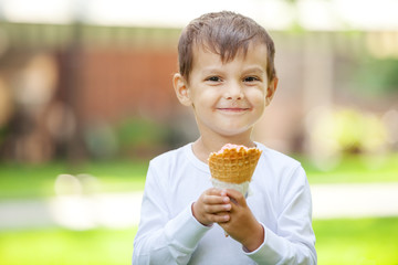 Portrait of young boy eating ice cream outdoors
