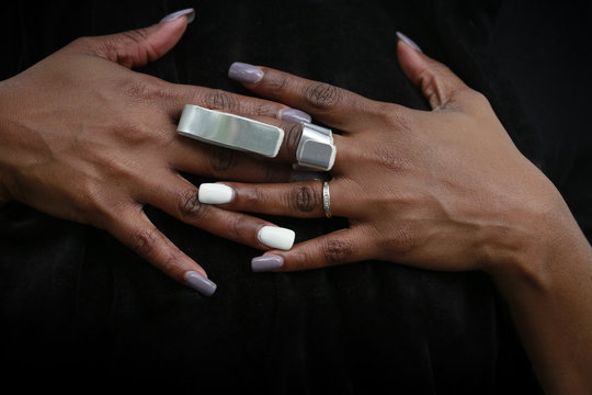 Nicely manicured hands of African-American woman with cast for arthritis or fractured finger