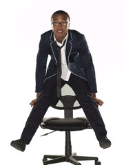 portrait view of a businessman balancing on chair over white background.