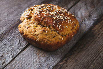 Freshly baked homemade bread on rustic wood background