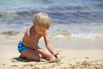 happy kid playing on a beach