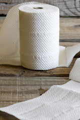Toilet paper roll on old wooden board