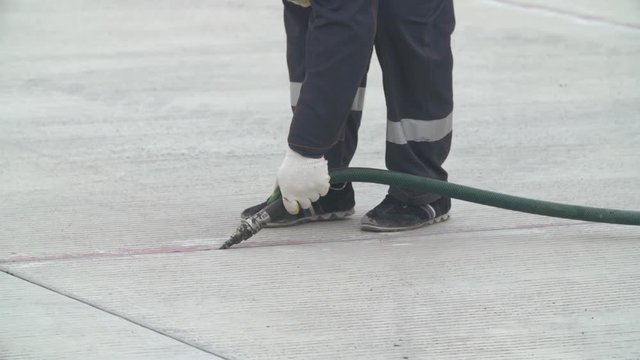 Concrete blocks seam sealing or joint sealing process at the construction site. Slow motion close up shot.  