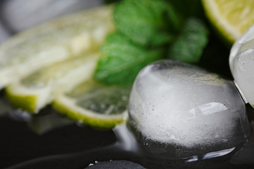 Fresh lime, mint and ice cubes. Dark background