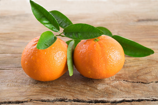 Two mandarins orange (tangerines) on wooden background