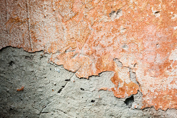 Concrete surface with the remains of orange paint and whitewash