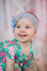 Adorable little baby girl laughing, smiling, creeping & playing in the studio wearing mint dress