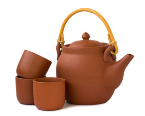 Clay teapot with cups isolated on white background