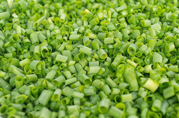 Background of chopped green shallots close-up studio shot