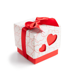 Gift box with two red hearts on side on white background